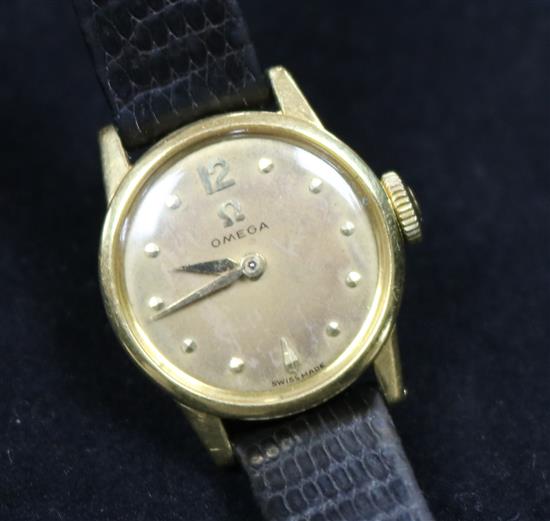 A ladys 1950s 18ct gold Omega manual wind wrist watch.